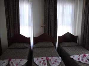 Ein Bett oder Betten in einem Zimmer der Unterkunft Antik Ridvan Hotel