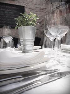 a table with white plates and wine glasses on it at Apartment Francos in Primošten