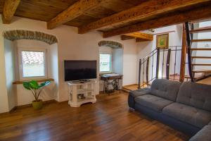 a living room with a couch and a flat screen tv at Hiša Margarita in Ajdovščina