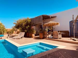a swimming pool in front of a house at El MELK MANSOUR in Essaouira