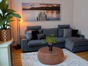 a living room with a blue couch and a table at Fewo Sweethome Lutherstadt Wittenberg - zentral gelegen in ruhiger Seitenstraße, inklusive Parkplatz und 2 Min Fußweg zur Schlosskirche in Lutherstadt Wittenberg +25 photos