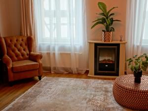 a living room with a chair and a fireplace at Fewo Sweethome Lutherstadt Wittenberg - zentral gelegen in ruhiger Seitenstraße, inklusive Parkplatz und 2 Min Fußweg zur Schlosskirche in Lutherstadt Wittenberg
