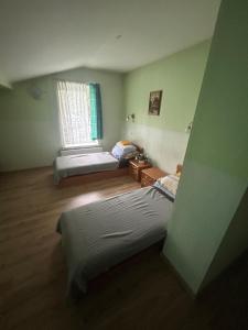 a room with two beds and a window at Viršutinė 9 3 kambarys in Klaipėda