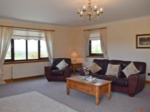 a living room with two couches and a coffee table at Lawford Lodge in Bonnybridge