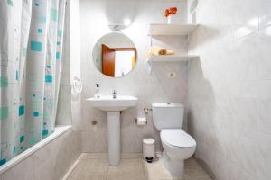 a bathroom with a toilet and a sink and a mirror at ED. MISTRAL VIDABER in Oropesa del Mar +47 photos