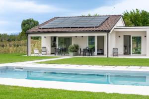 a house with solar panels on the roof at Armonia Suites - Terra e Acqua in Verona