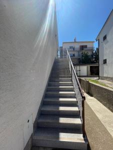 a staircase leading up to a building with the sun shining on it at Room Vera in Senj +1 photo