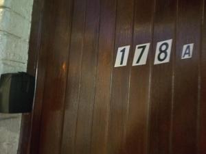a wooden elevator door with numbers on it at Beach Rock Cottage in Kiddʼs Beach +3 photos