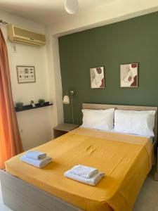 a bedroom with a bed with two towels on it at Central Apart. 4U in Ierapetra