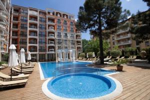 a large swimming pool in front of a building at Patrick's apartments - Harmony Palace in Sunny Beach