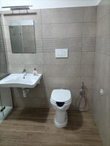 a bathroom with a toilet and a sink at D&Dhome in Mola di Bari +4 photos