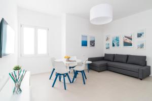 a living room with a couch and a table and chairs at Puolo Seaside Apartment 3 in Massa Lubrense