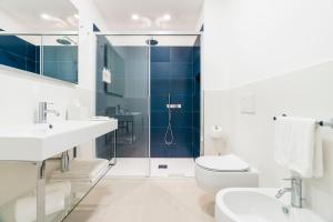 a bathroom with a shower and a toilet and a sink at Puolo Seaside Apartment 3 in Massa Lubrense