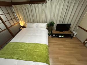 Letto o letti in una camera di Villa FUNABASHI
