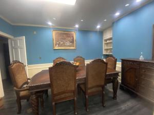 a dining room with a wooden table and chairs at Best value 3 Huge Bedrooms-Multiple parkings in Willmar