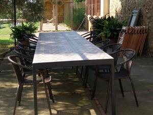 a table and chairs sitting around a patio at Agroturisme MAS CAN FONT in Ventalló