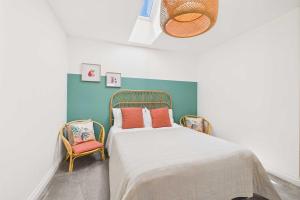 a bedroom with a bed and two chairs at Host & Stay - Cringle Cottage in Stokesley +12 photos