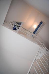 a staircase in a room with a white shelf at Hotel Villa Denia in San Vincenzo +79 photos