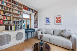 a living room with a couch and bookshelves at Villa Seeblick 1908 in Bregenz