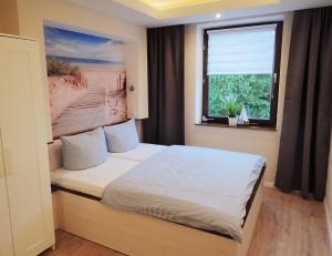 Ein Bett oder Betten in einem Zimmer der Unterkunft Strandfeeling