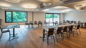 a large room with tables and chairs in it at Aarau West Swiss Quality Hotel in Oberentfelden