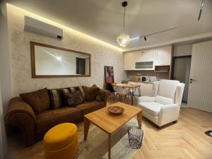 a living room with a couch and a table at Grand Lake View Apartment in Ohrid