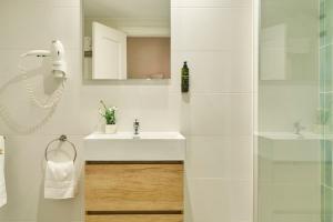 a white bathroom with a sink and a shower at Ona Campanario in La Cala de Mijas