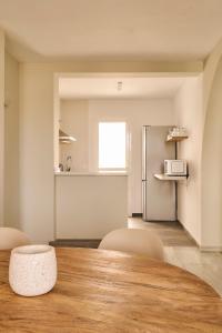 a kitchen with a table and chairs and a refrigerator at Ona Campanario in La Cala de Mijas