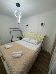 a bedroom with a large bed with two pillows on it at White Home in K'obulet'i