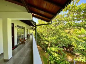 an outside view of a house with a porch at Villa Kaya in Hikkaduwa