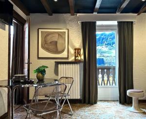 a dining room with a table and chairs and a window at Tatiana II in Megève