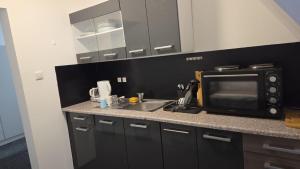 a kitchen with a sink and a microwave at Aydogan Vermietung in Stade
