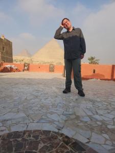 a man standing in front of a pyramid at Energy Of Pyramid Hotel in Cairo +101 photos