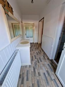 a room with a staircase and a white floor at Casa Rica Vendégház in Sovata