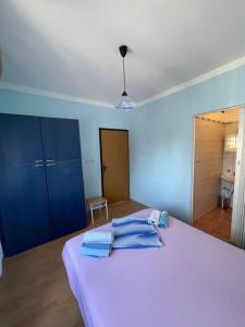 a bedroom with a bed with towels on it at Room Vera in Senj