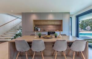 una cucina con un grande tavolo e sedie in legno di Stunning Home In Pomer With Sauna a Pomer