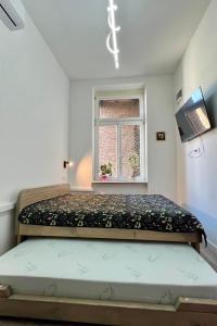 a bed in a room with a window at The Bell Studio in Sarajevo