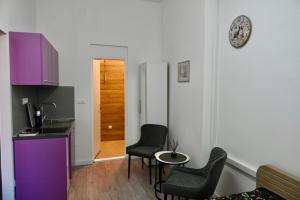 a kitchen with two chairs and a table in a room at The Bell Studio in Sarajevo