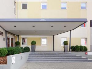 a building with steps leading up to a building at ibis Stuttgart Airport Messe in Leinfelden-Echterdingen