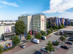 a city with cars parked in a parking lot at ibis Stuttgart Airport Messe in Leinfelden-Echterdingen