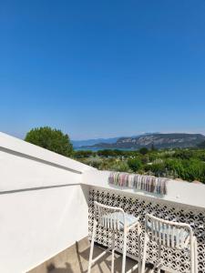 two chairs on a balcony with a view of the ocean at Bardolino Blue in Bardolino