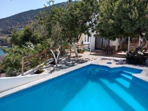 a villa with a swimming pool and trees at Muses seaside Villas in Paralio Astros