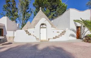 a white house with stairs and a door at Cozy Home In Ceglie Messapica in Ceglie Messapica