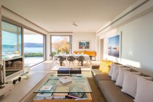 a living room with a couch and a table at Paradise Beachfront Villa Athenian Riviera in Aghia Marina +36 photos