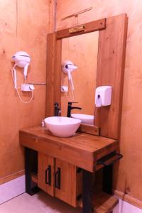 a wooden bathroom with a sink and a mirror at Butterfly Valley Beach Glamping in Fethiye +97 photos
