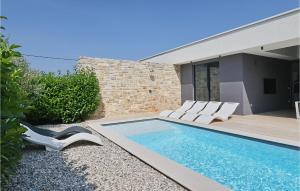 a swimming pool with white chairs and a house at Villa K3 in Zadar +37 photos