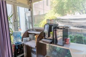a room with a table with a coffee maker on it at Vila 18 Hotel Boutique in Bucharest +106 photos