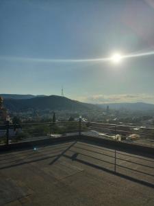 a view of a city from a balcony at SKY Hotel Old Tbilisi in Tbilisi City
