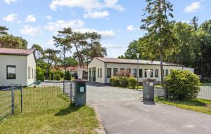 a house with two trash cans in front of it at Gorgeous Apartment In Altenkirchen in Altenkirchen