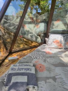 a bed in a room with a window at MAS BERRUGUES in Bélesta